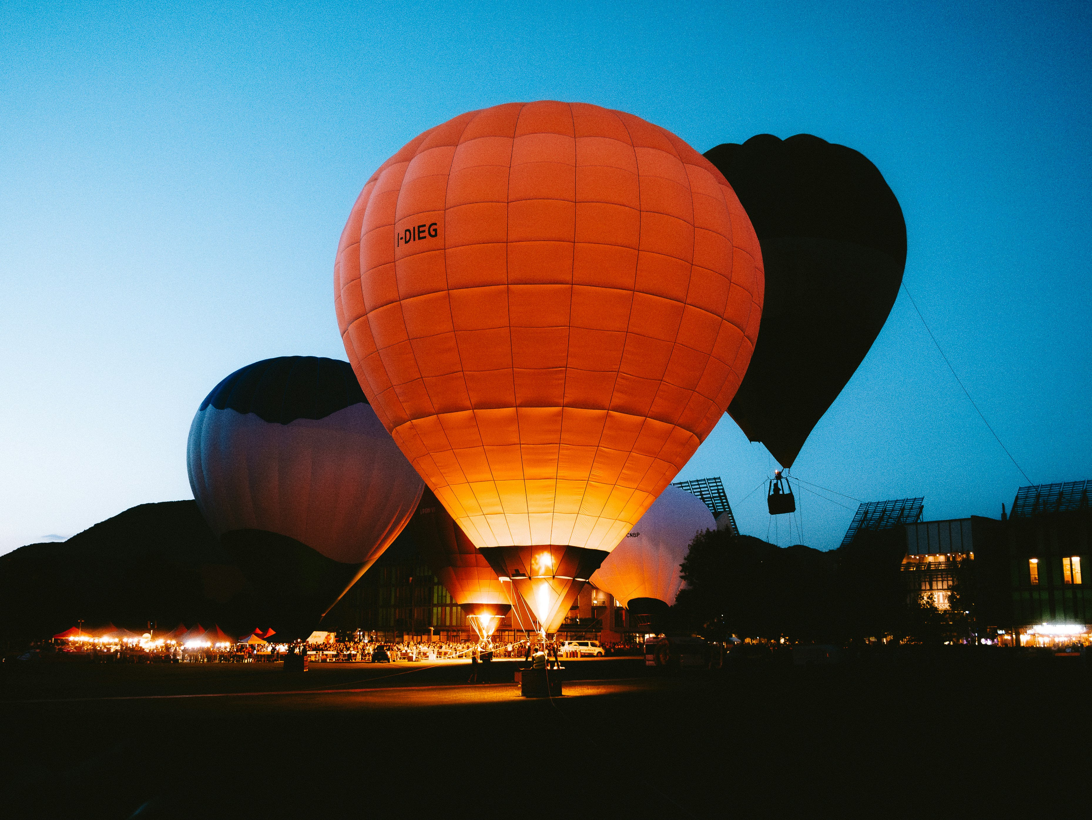 Hot Air Balloons Glowing At Twilight Against A Dark Sky. HD mobile wallpaper