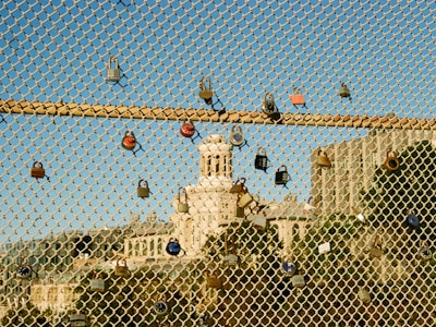 Colorful Locks On A Metal Grid Along The Bridge