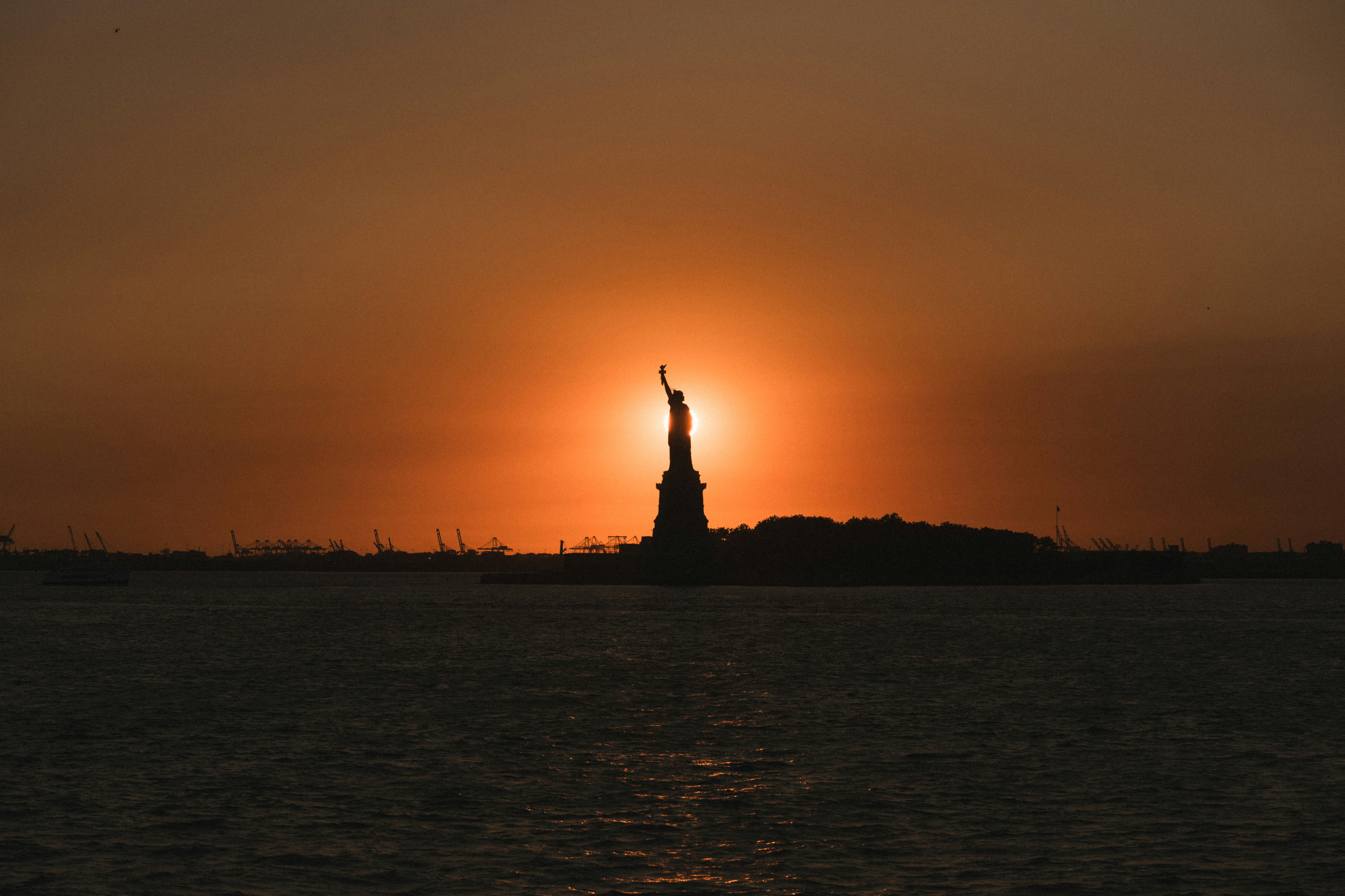 New York Statue Of Liberty Silhouetted At Sunset HD mobile wallpaper