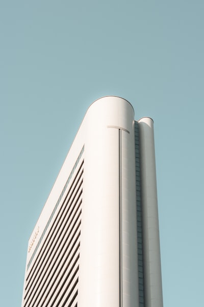 Modern White Building Against A Clear Blue Sky. wallpaper preview