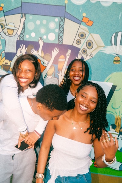 Four Friends Laughing In Front Of A Mural wallpaper preview