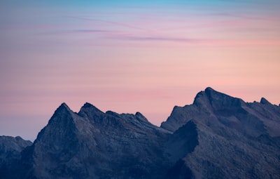 Jagged Mountain Peaks Under A Pastel Sky wallpaper preview