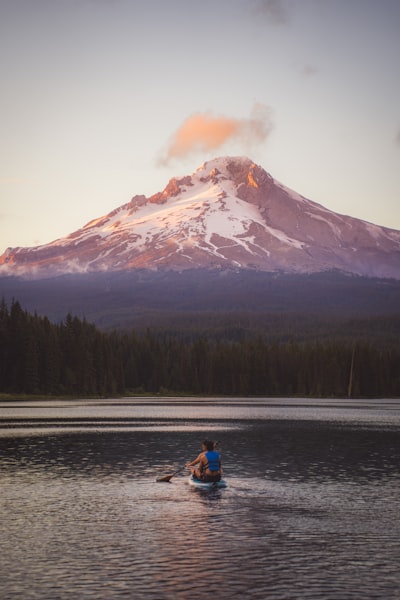 Paddleboarder On A Lake With A Snow-capped Mountain At Sunset. wallpaper preview