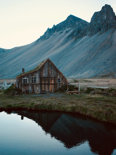 乡村木屋映照在水中的倒影，远处的山峰如画壁纸预览