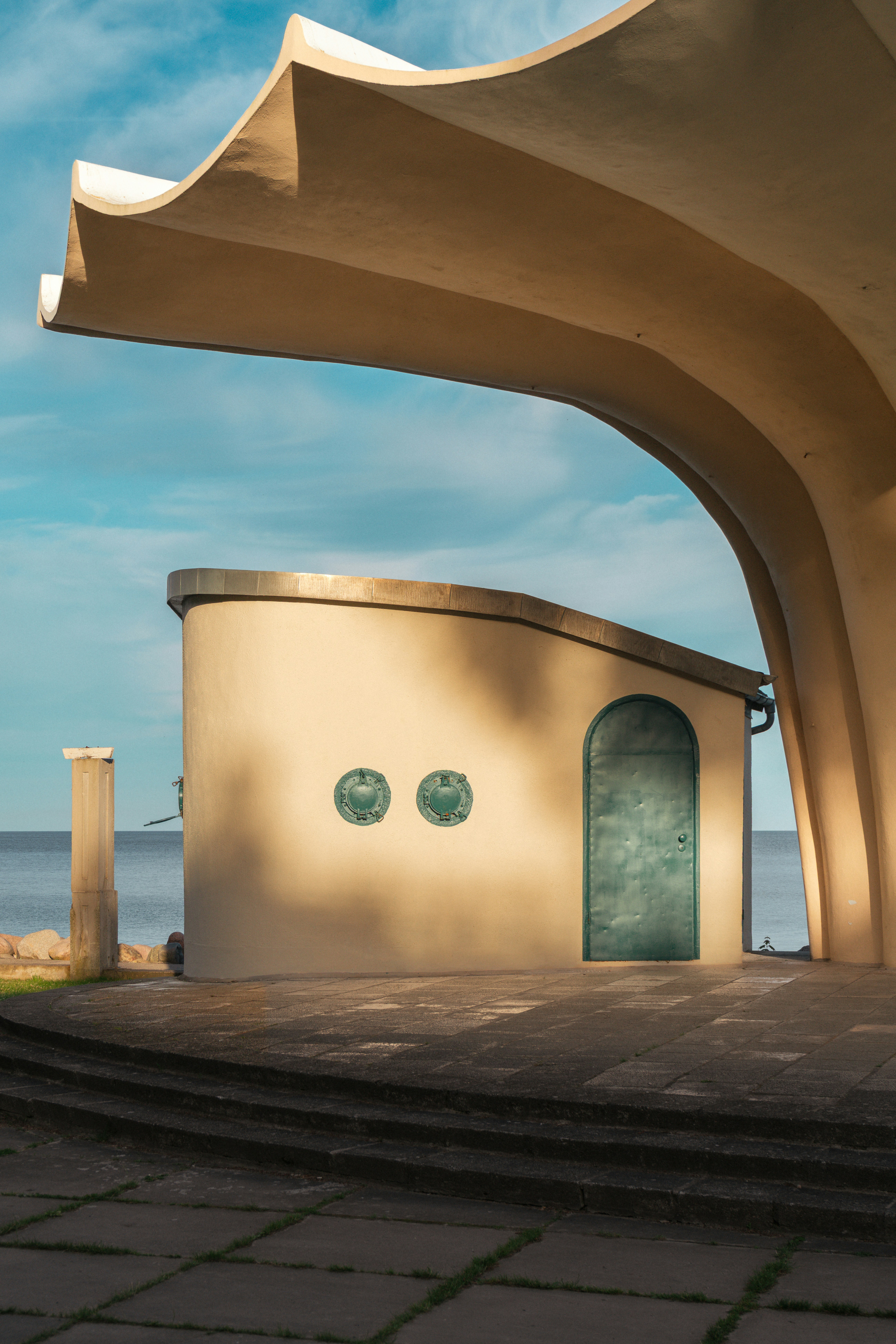 Architectural Building With A Green Door Overlooking The Blue Ocean. HD mobile wallpaper