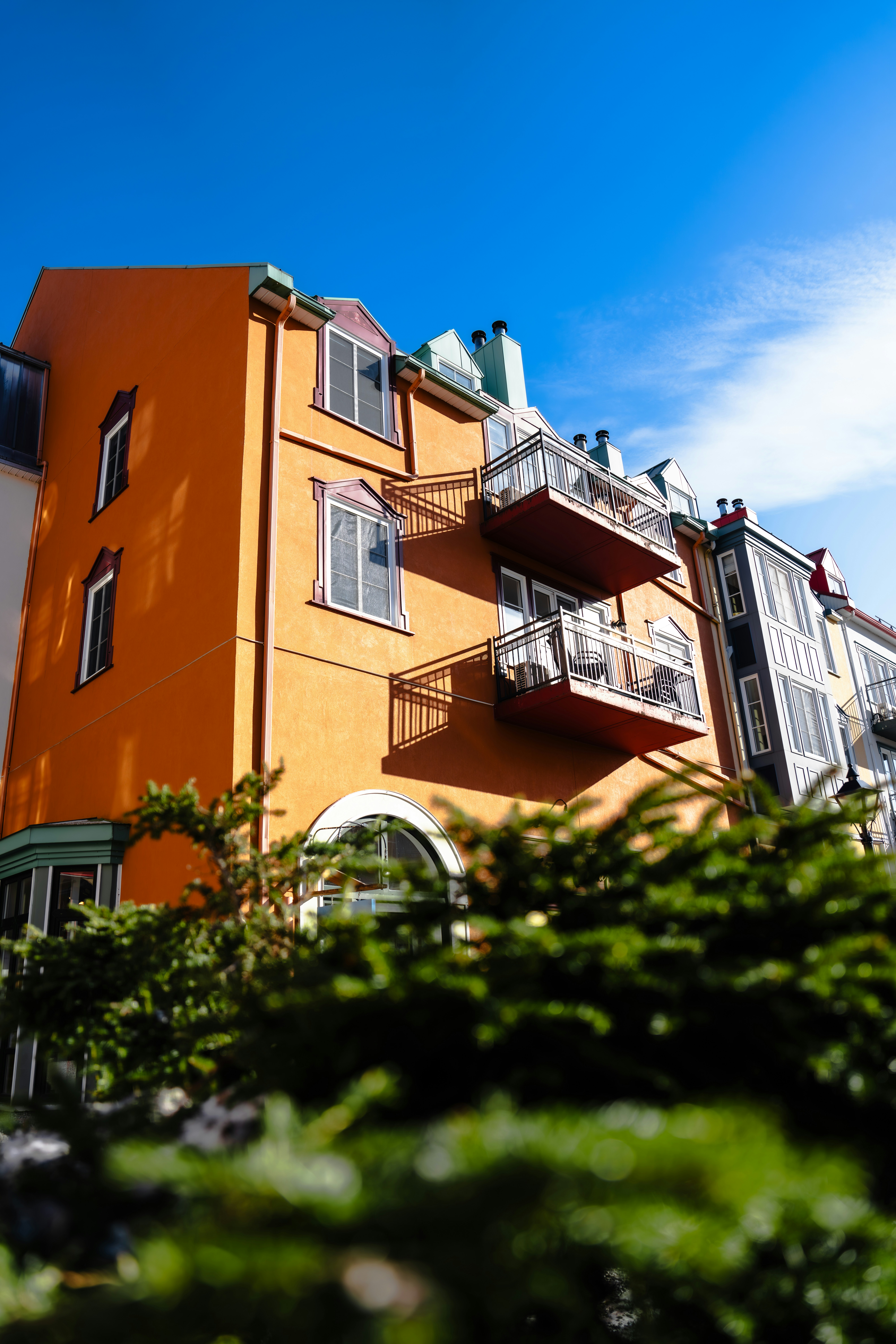 An Orange Building With Balconies And Balconies On The Balconies
